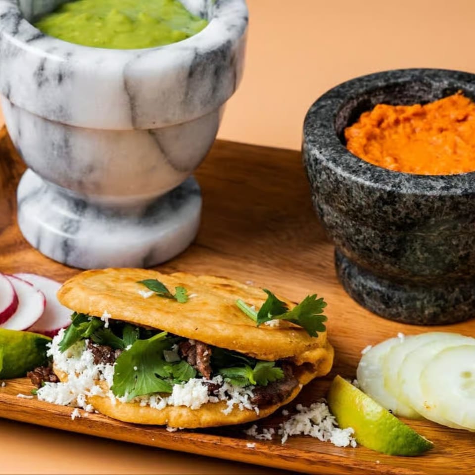 La Familia's Mexican gordita with meat, cheese, and cilantro, served with guacamole and salsa.